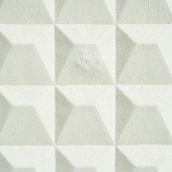 Intricate geometric white wall pattern with 3D textures creating a modern abstract design.